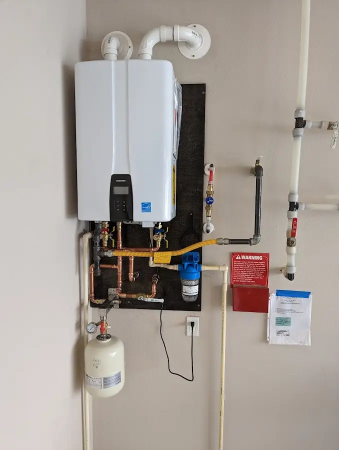 Professional plumber installing copper piping in a Wethersfield home